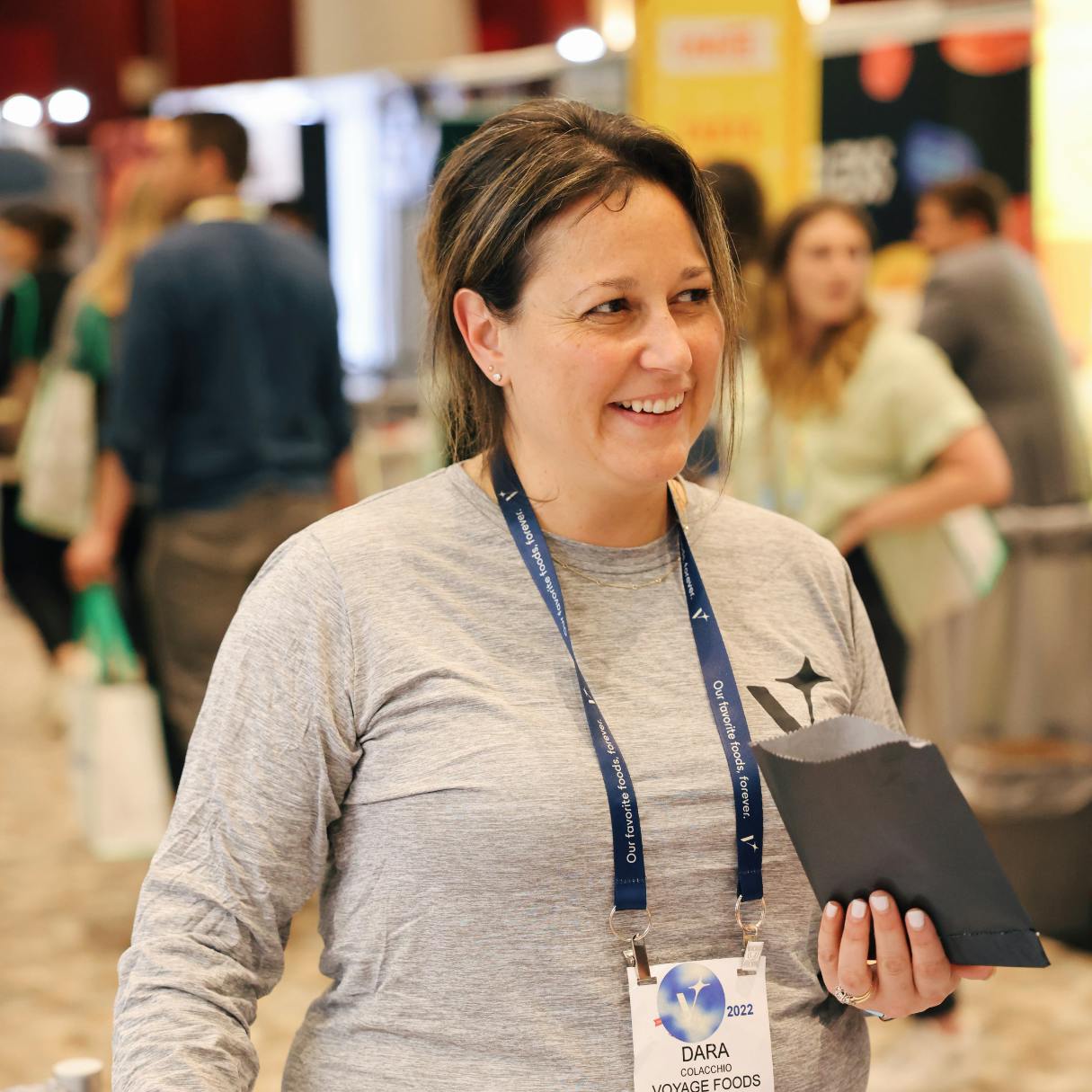 image of woman with a voyage foods badge at trade show