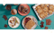 close up photo of a variety of foods made with voyage foods products including peanut-free spread and jelly on toast, cocoa-free chocolate chip cookies, nfs on applies